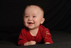 studio portrait of a smiling and laughing baby