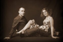 artistic sepia tone portrait of couple with legs tangled